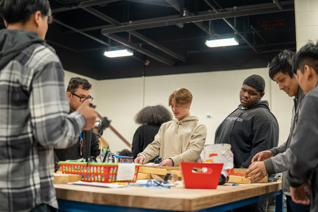 "Okay but how cool is this??? The Robotics Class held a tournament style Battlebots event!  Students could only create their bots using recycled materials found in the room and then only had 5 minutes to race to get the most cones to their score area!" 
