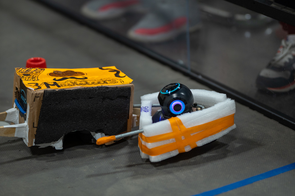 "Okay but how cool is this??? The Robotics Class held a tournament style Battlebots event!  Students could only create their bots using recycled materials found in the room and then only had 5 minutes to race to get the most cones to their score area!" 